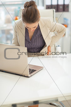 Closeup on business woman with back pain