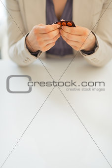 Closeup on business woman taking pill from blister pack