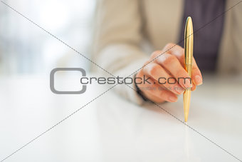 Closeup on business woman holding pen
