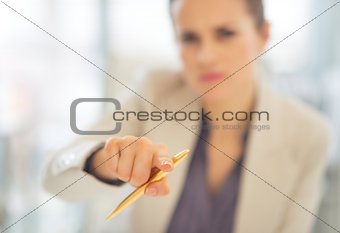 Closeup on business woman pointing with pen