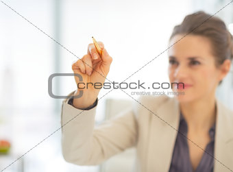 Closeup on business woman writing in air with pen
