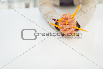 Closeup on business woman holding pencils