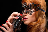 Gorgeous redhead woman with retro microphone 