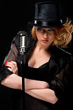 Gorgeous stylish redhead woman with retro microphone 