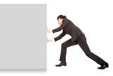 Young businessman pushing a blank board on white background