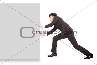 Young businessman pushing a blank board on white background