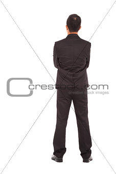 full length of businessman standing and cross arms