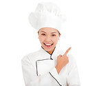 Portrait of young woman chef pointing direction