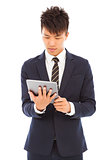  young businessman holding a tablet and watching screen