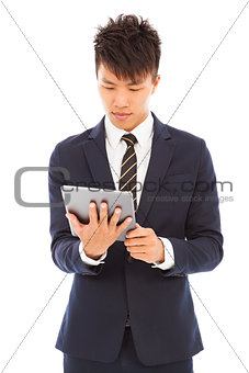  young businessman holding a tablet and watching screen
