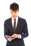  young businessman holding a tablet and touching screen