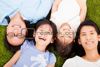 happy family lying on a meadow together