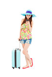 young woman looking the smart phone with  travel baggage
