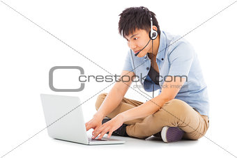Young man relaxing on floor and learning language