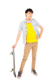 funky young man standing and holding a skateboard