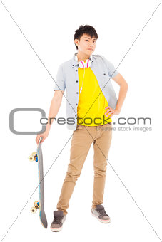 funky young man standing and holding a skateboard
