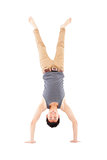young man doing a handstand against on white background