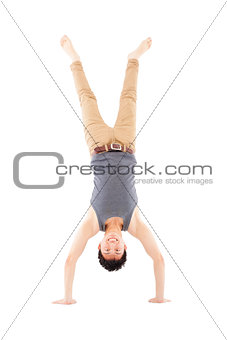 young man doing a handstand against on white background