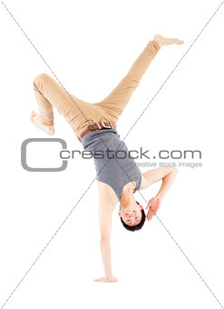 Young man dancing a breakdance and handstand pose