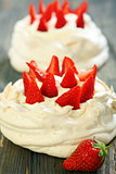 Pavlova dessert with strawberries and lemon cream.