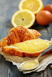 Lemon curd on a slice of fresh croissant.  