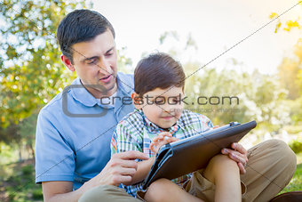 Handsome Mixed Race Father and Son Playing on Computer Tablet
