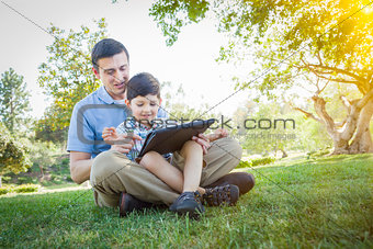 Handsome Mixed Race Father and Son Playing on Computer Tablet