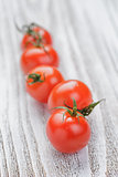 cherry tomatoes on white painted wood table