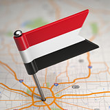 Yemen Small Flag on a Map Background.