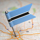 Botswana Small Flag on a Map Background.