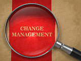 Change Management. Magnifying Glass on Old Paper.