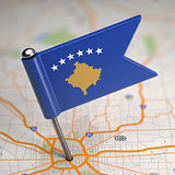Kosovo Small Flag on a Map Background.