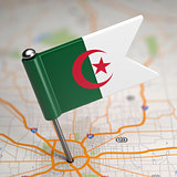 Algeria Small Flag on a Map Background.