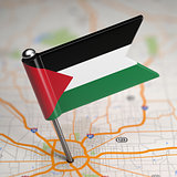 Palestine Small Flag on a Map Background.