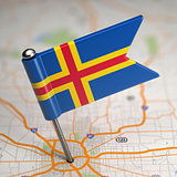 Aland Islands Small Flag on a Map Background.