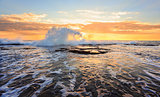 Sunrise seascape splash in the shape of a wave