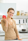 Portrait of happy young woman apple in kitchen