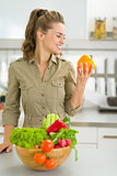Portrait of young housewife with fresh vegetables in modern kitc