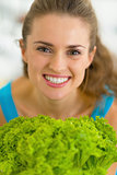 Portrait of happy young woman with fresh salad