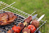 Cooking on the barbecue grill assortment sausages steak and skewers