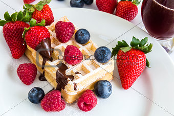 sweet fresh mixed fruits with tasty waffles and red juice