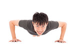 smiling young man make push-ups and fitness