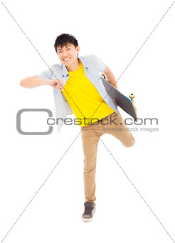 Vibrant young man holding a skateboard and make a pose