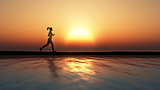 Female jogging against a sunset ocean