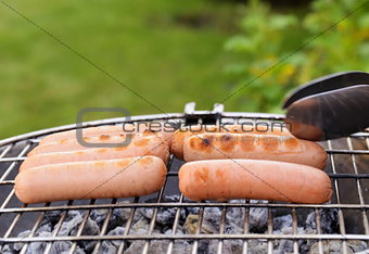 roasted sausages on a barbecue grill outdoors picnic