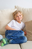 Young boy sitting on the sofa