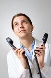 Unhappy doctor with phone receivers