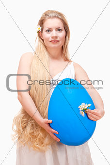 Young Woman with Long Blond Hair and Large Blue Egg. 