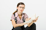 Young woman in glasses reading a book