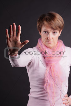 mature woman with a raised open hand